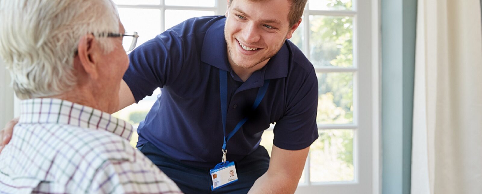 healthcare worker smiling at older man